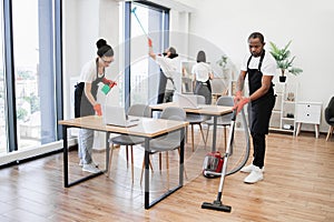 Team of young multicultural cleaners .