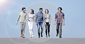 Team of young people walking along the road.outdoors