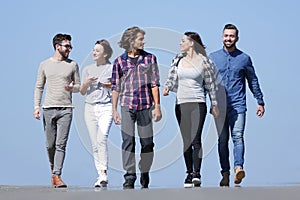 Team of young people walking along the road.outdoors