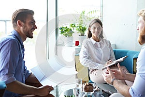 Team young professionals having casual discussion in office. Executives having friendly discussion during break.