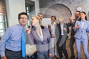 Teambuilding indoors activity. Business people making team training exercise during team building seminar singing karaoke