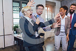 Teambuilding indoors activity. Business people making team training exercise during team building seminar singing karaoke