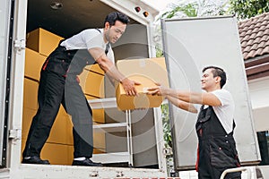 Teamwork in action, removal service workers unload boxes and furniture from the