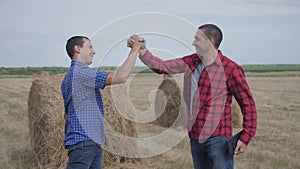 Teamwork agriculture smart farming concept. two men farmers business having firm friendly handshake workers shake hands