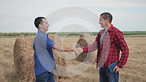 Teamwork agriculture smart farming concept. Two men farmers business having firm friendly handshake workers shake hands