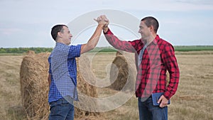 Teamwork agriculture smart farming concept. two men farmers business having firm friendly handshake workers shake hands