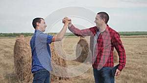 Teamwork agriculture smart farming concept. Two men farmers business having firm friendly handshake workers shake hands