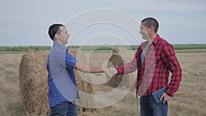 Teamwork agriculture smart farming concept. Two men farmers business having firm friendly handshake workers shake hands