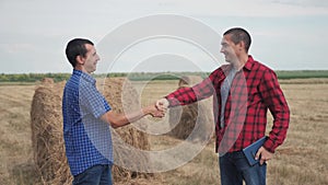 Teamwork agriculture smart farming concept. two men farmers business having firm friendly handshake workers shake hands