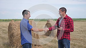 Teamwork agriculture smart farming concept. two men farmers business having firm friendly handshake workers shake hands