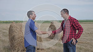 Teamwork agriculture smart farming concept. two men farmers business having firm friendly handshake workers shake hands