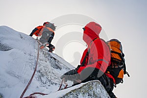 Teamwork in alpinism. Mountaineering. Traverse of mountain. photo