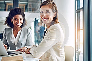 Teamwork is for the benefit of everyone. Portrait of a two corporate businesswomen working together in an office.