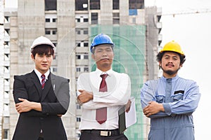 Teamwork of building construction. Team of asian architect/engineer/foreman working together at construction site