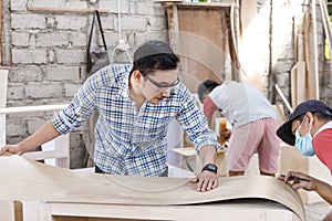 Teamwork building a furniture at carpenter workshop