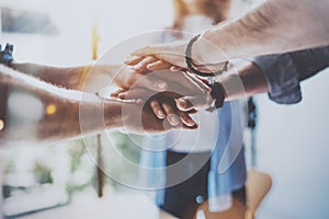 Teamwork business concept.Close up view of group of three coworkers join hand together during their meeting. Horizontal