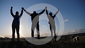 Teamwork business concept. happy family a silhouette hold hands up hold hands for joy and happiness. concept business