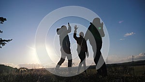 Teamwork business journey concept win. happy family a team man, woman and kids sunset silhouette help shake hands