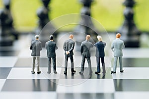 Teamwork in business strategy concept, group of miniature people