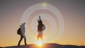 Teamwork business travel concept. two hikers gives hand winter snow tourists climbers climb to the top of the mountain