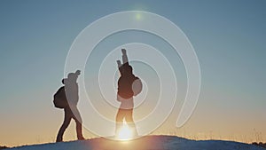 Teamwork business travel concept. two hikers gives hand winter snow tourists climbers climb to the top of the mountain