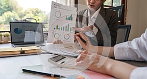 Teamwork of business two colleagues analysis with financial data and marketing report graph, Young business woman two co