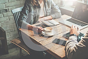 Teamwork. Businessman and businesswoman sitting at table in coffee shop and discuss business plan. photo