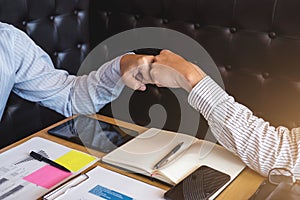 Teamwork of businessman partnership giving fist bump to greeting