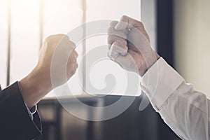 Teamwork of businessman partnership giving fist bump to greeting