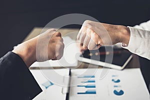 Teamwork of businessman partnership giving fist bump to greeting