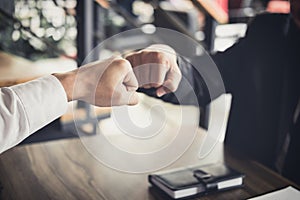 Teamwork of businessman partnership giving fist bump to greeting