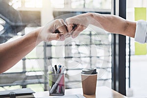 Teamwork of businessman partnership giving fist bump to greeting