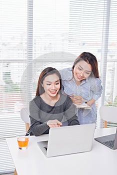 Teamwork. Businesspeople working together with laptop in office.