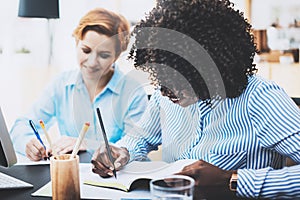 Teamwork concept of beautiful womans making business meeting in modern office. Group girls coworkers discussing together new