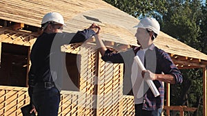 Teamwork. concept building constructing architect slow motion video. two men builder in helmets shake hands lifestyle