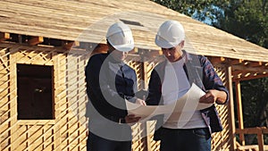 Teamwork. concept building constructing architect slow motion video. two men builder in helmets study digital tablet the