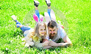 Teamwork concept. Dad and girl found easter eggs in traditional hunting game in. Man with beard and cute child lay on