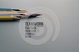 Teamwork concept. group of color pencil on black background with word Teamwork, Together, Everyone, Achieves and More