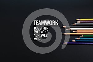 Teamwork concept. group of color pencil on black background with word Teamwork, Together, Everyone, Achieves and More photo