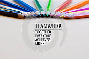 Teamwork concept. group of color pencil on brown background with word Teamwork, Together, Everyone, Achieves and More