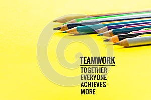 Teamwork concept. group of color pencil on yellow background with word Teamwork, Together, Everyone, Achieves and More