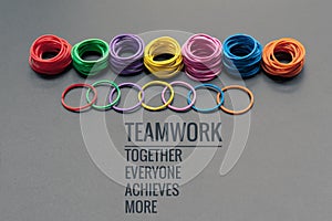 Teamwork concept. group of colorful rubber band on black background with word Teamwork, Together, Everyone, Achieves and More