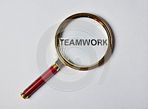 Teamwork concept. Magnifying glass focused on word