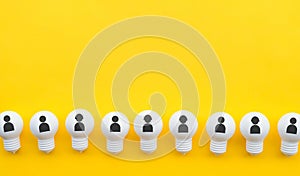 Teamwork concepts with human icon on group of lightbulb on pastel color background.Business solution