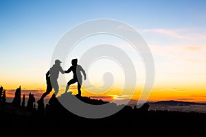 Teamwork couple climbing with helping hand