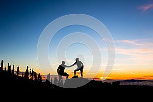 Teamwork couple climbing with helping hand