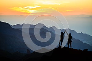 Teamwork couple climbing helping hand