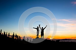 Teamwork couple climbing and reaching mountain peak