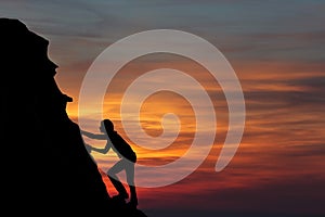 Teamwork couple hiking help each other trust assistance silhouette in mountains, sunset. Teamwork of man and woman hiker helping e