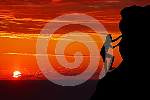 Teamwork couple hiking help each other trust assistance silhouette in mountains, sunset. Teamwork of man and woman hiker helping e